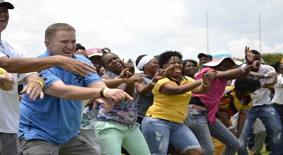 Group of people doing a team building war cry