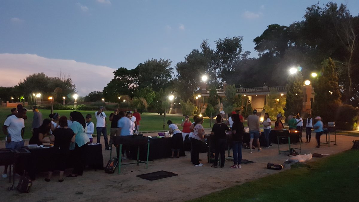 Colleagues taking part in an outdoor evening cook-off at a corporate function