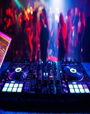DJ controller set up with the dance floor crowd blurred in the background