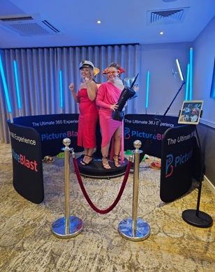 Guests posing with props at a Blue Hat Events photo booth