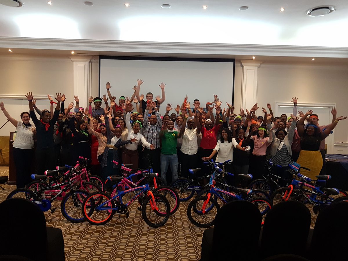 Corporate team celebrating after a charity bike build team building activity