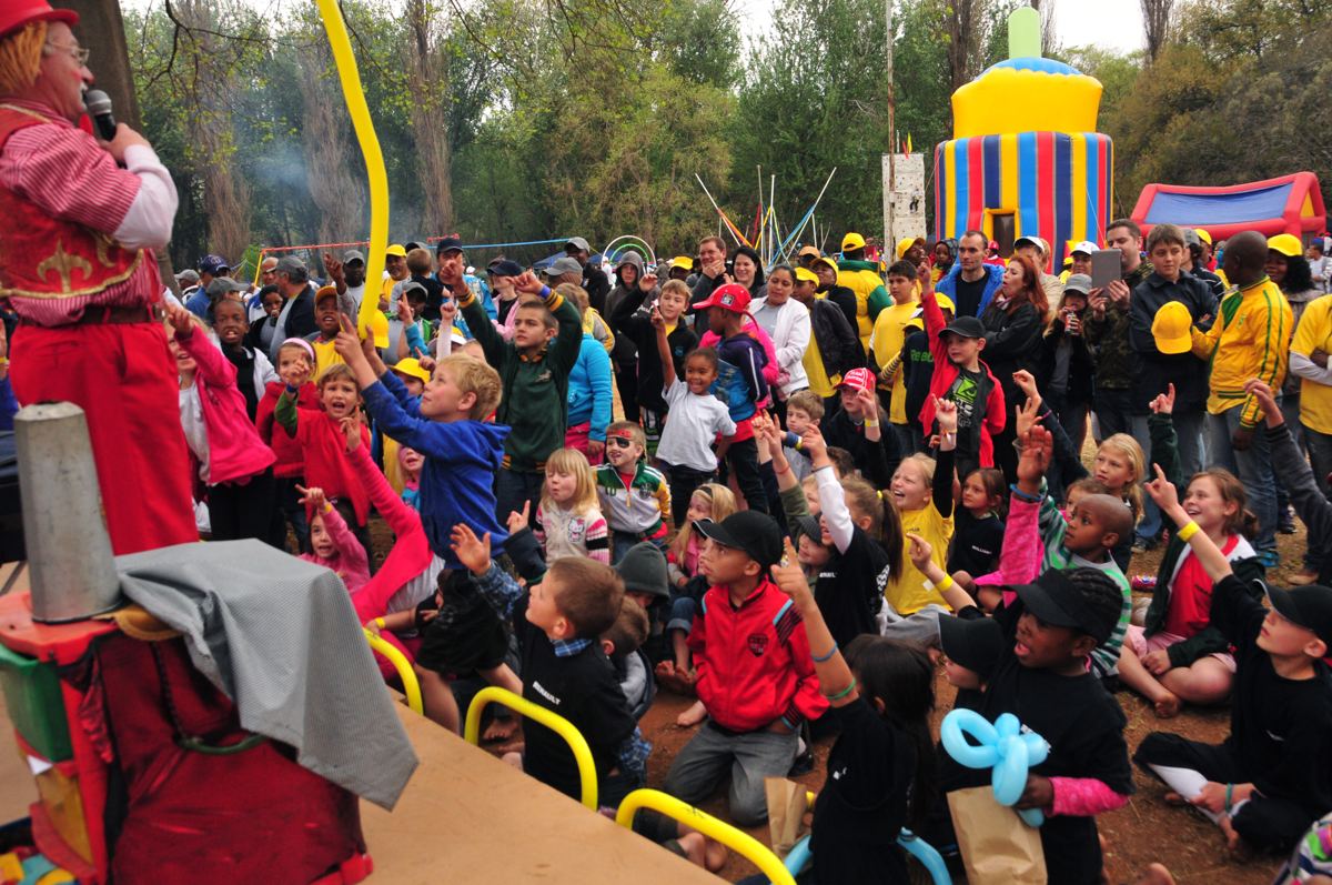 Children cheering at a kids' show at a year-end family day