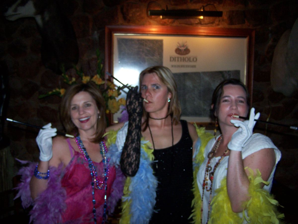 Guests in Roaring 20s flapper costumes with feather boas and pearls